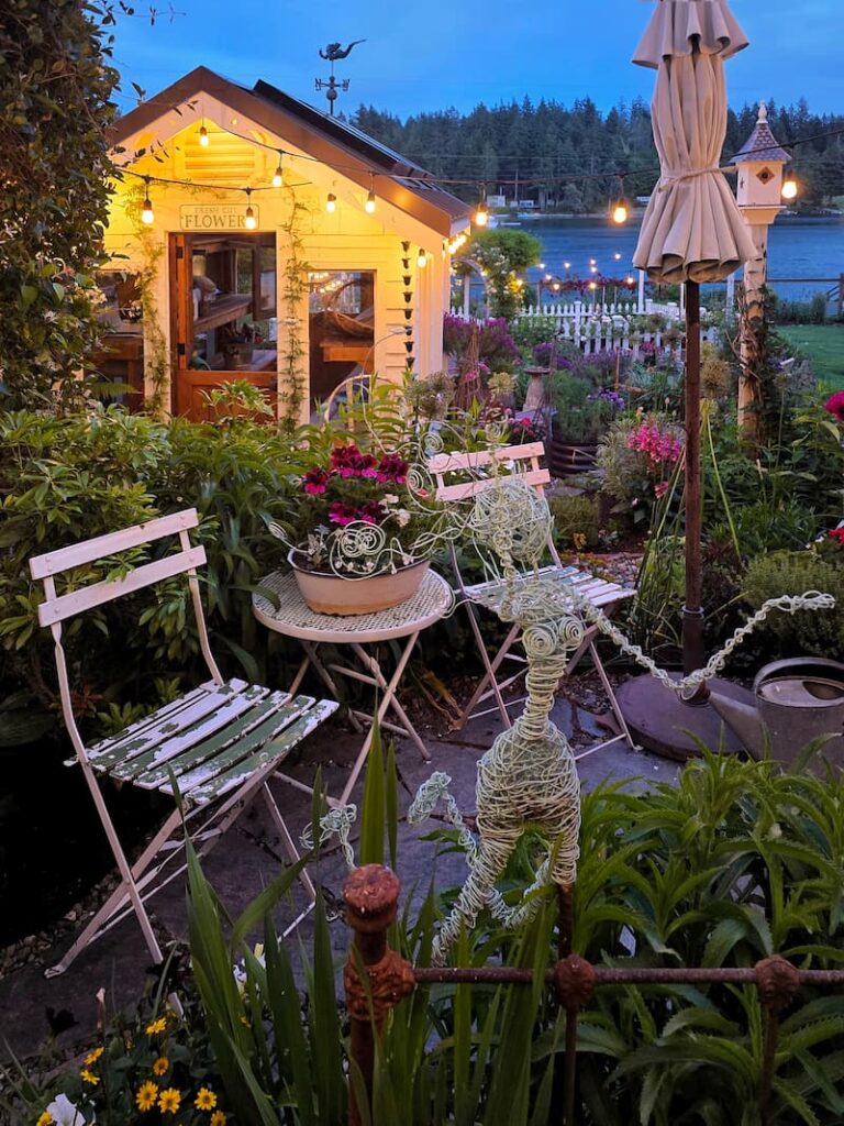 evening views with greenhouse and bistro table and chairs on patio