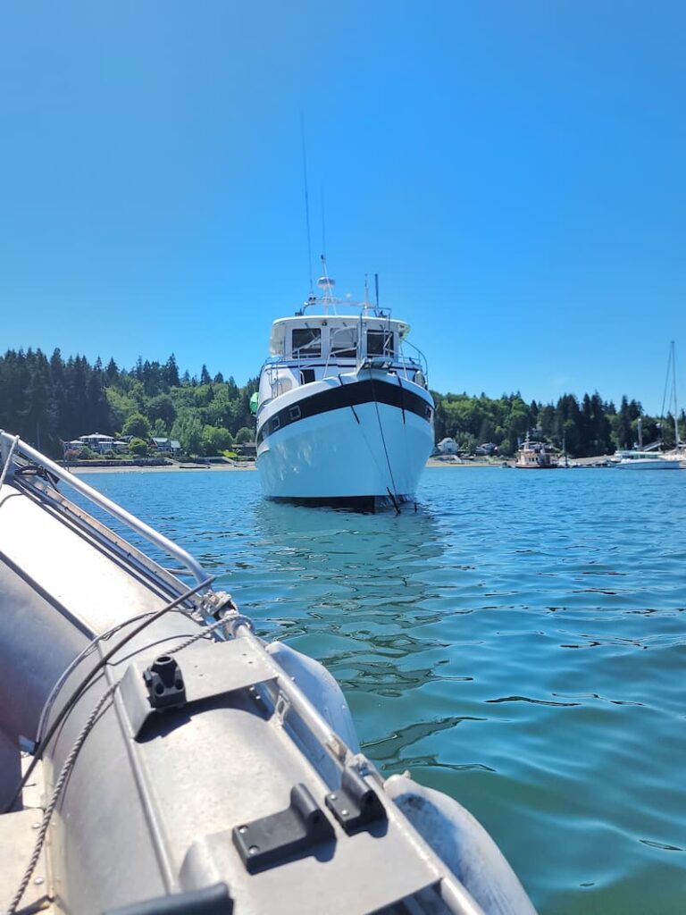view of a trawler from the dinghy in the water
