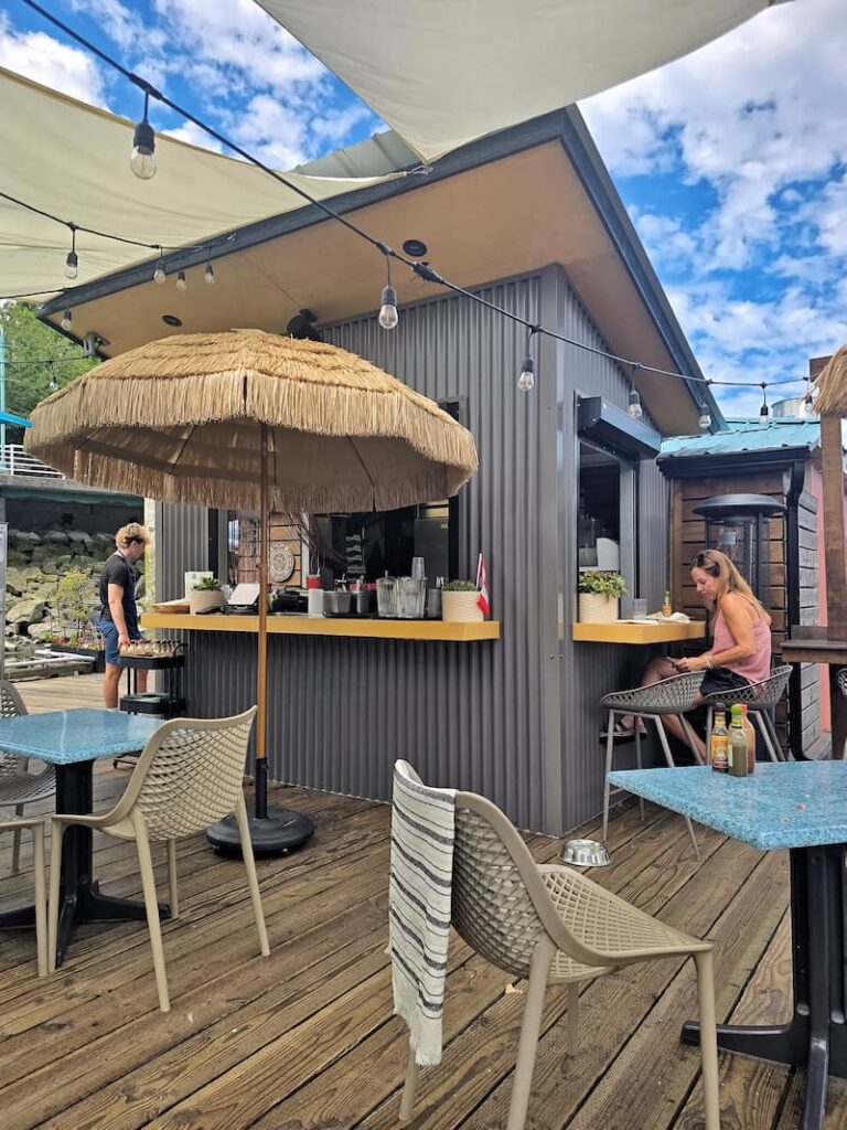 Penny's Palapa restaurant on the dock with bamboo umbrellas and tables