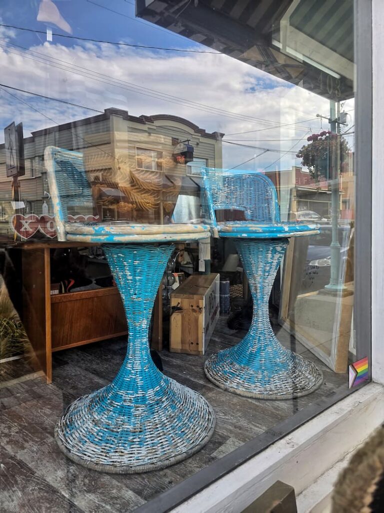 Red Shelf Decor vintage store in Nanaimo BC with turquoise wicker bar stools in the window