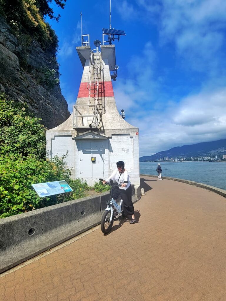 bike riding in front of the lighthouse at Stanley Park