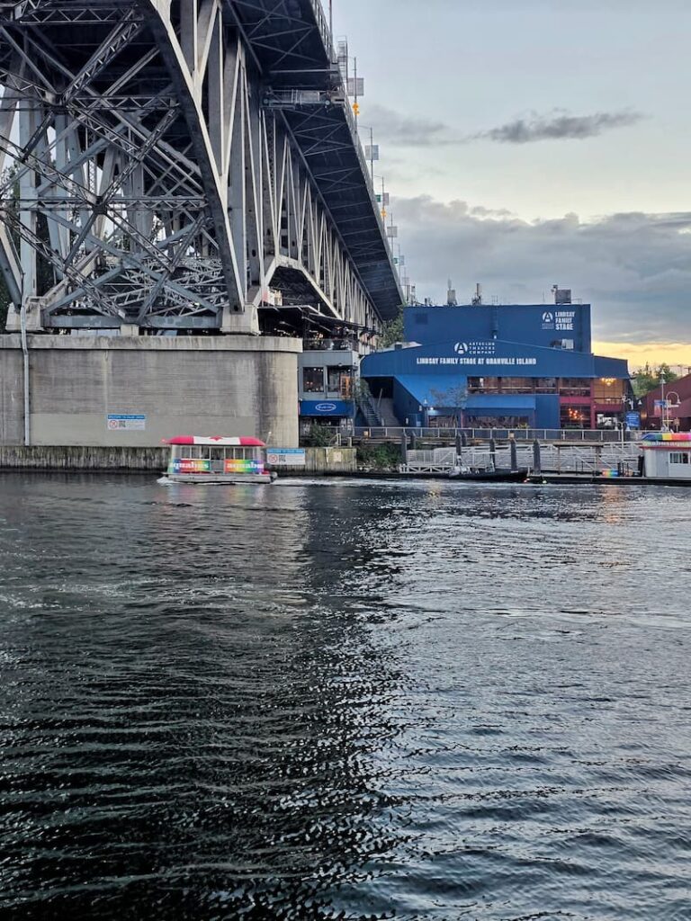 Granville Street Bridge and Granville Island from the water with Aquabus