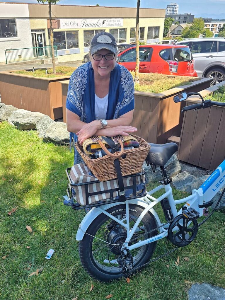 woman posing with a bike basket full of vintage decor