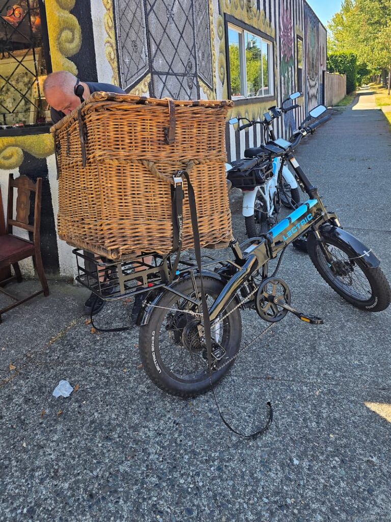 Carrying a vintage wicker trunk on a bicycle through Victoria BC