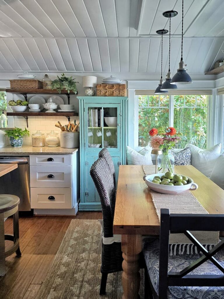 Cottage kitchen eating area with late summer light and garden flowers