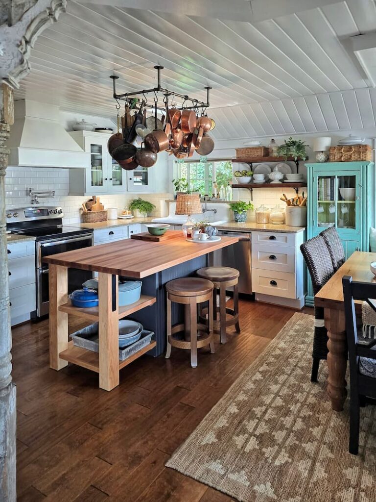 Cottage style kitchen with custom island and open shelving in a 1920 beach cottage