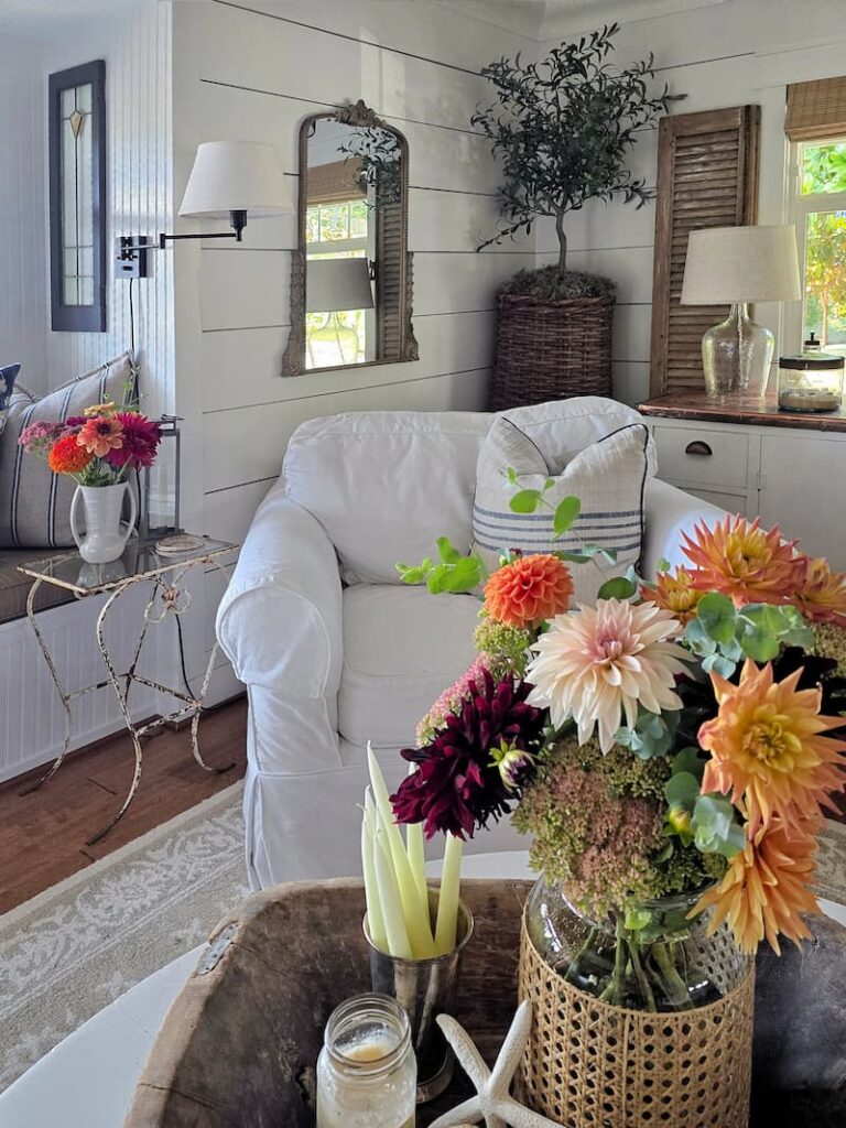 Cozy cottage living room with summer styling and fresh cut flowers in August
