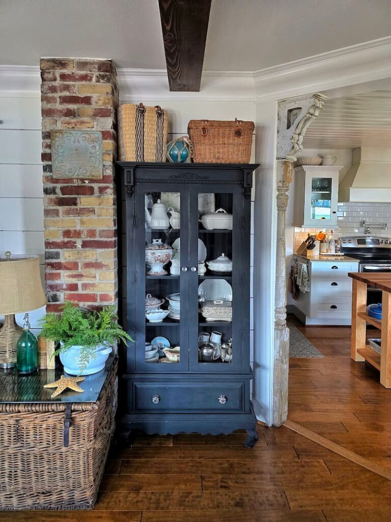 black cabinet with vintage white ironstone collection