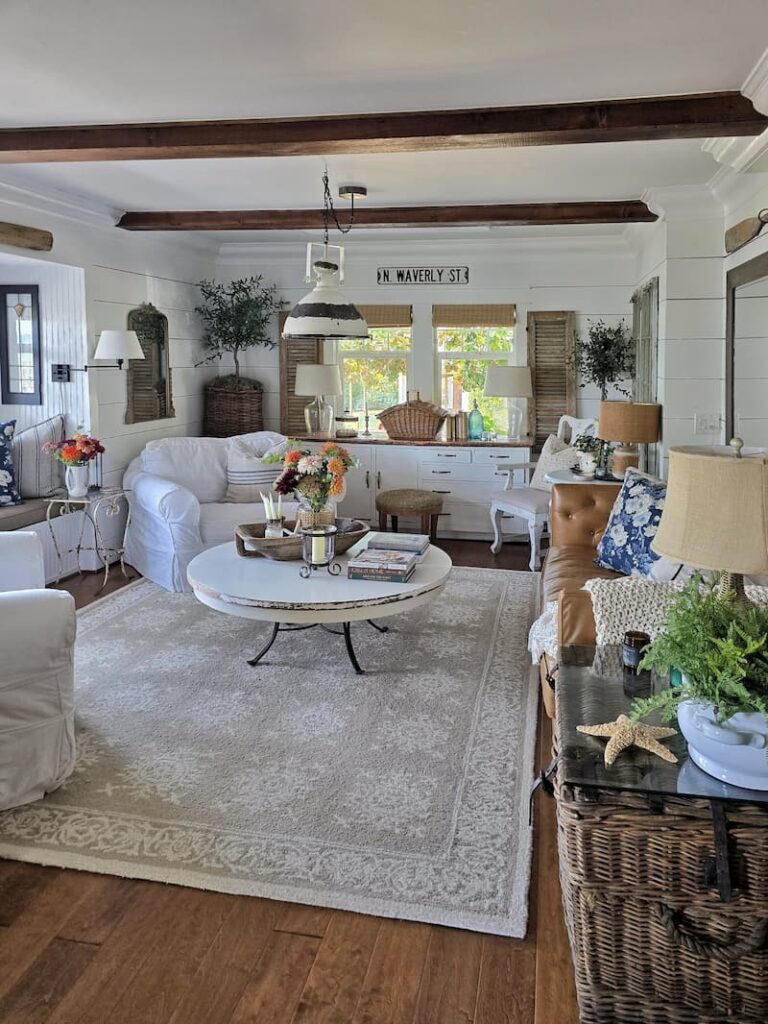 Cottage style living room decorated with fresh summer flowers in late August