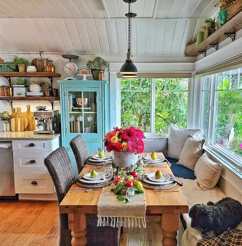 fall tablescape with outdoor elements like apples, pears, and a vintage galvanized bucket of dahlias