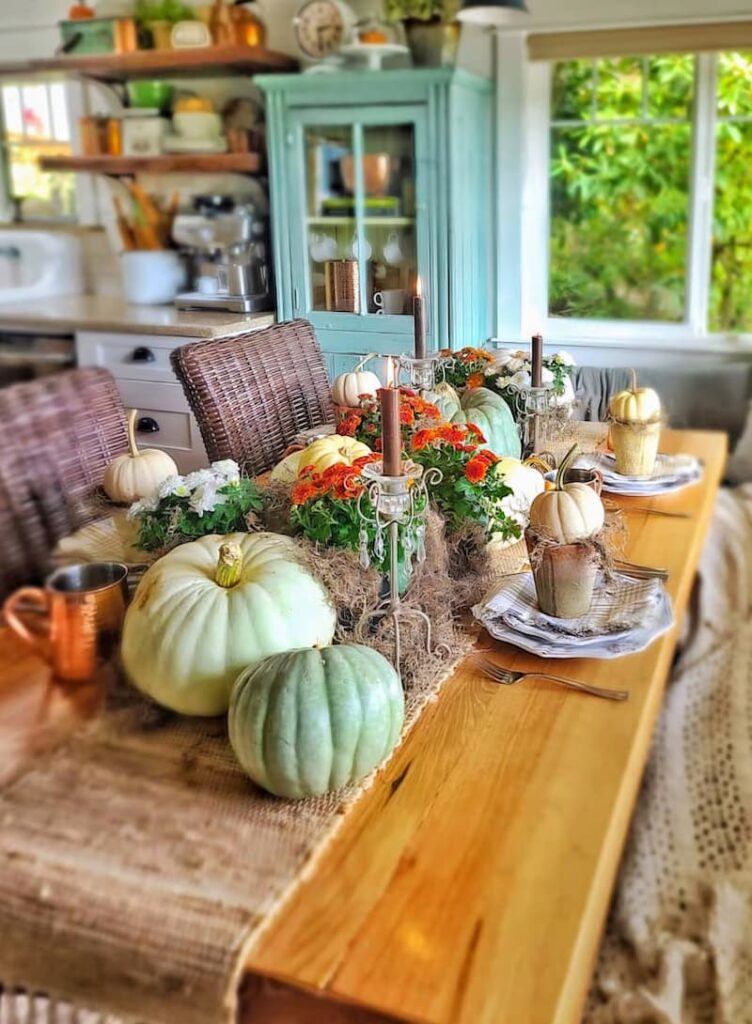 fall table using pumpkins, mums, copper, and candles