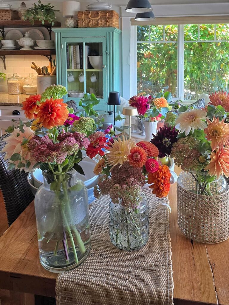 Colorful summer cut flowers in vases harvested from a cottage garden on Puget Sound