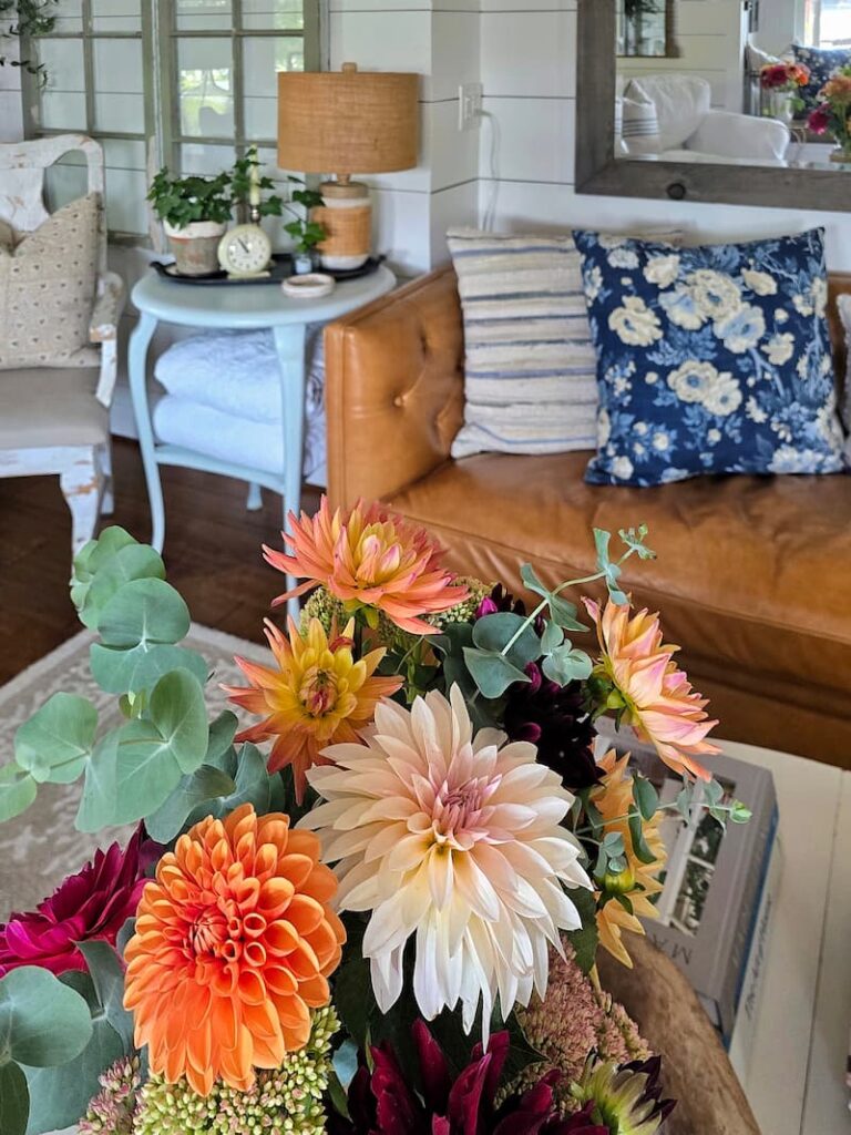 Summer cottage living room with vintage decor and fresh flowers from the garden