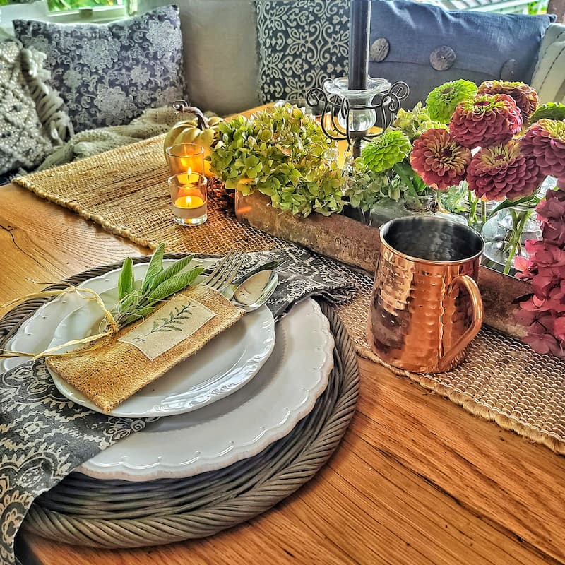 Fall tablescape with herbs and hydrangeas and a copper mug