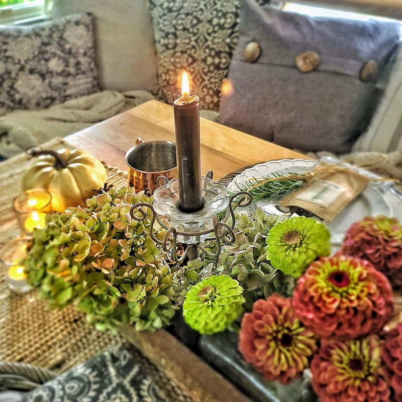hydrangeas, zinnias and candles on table