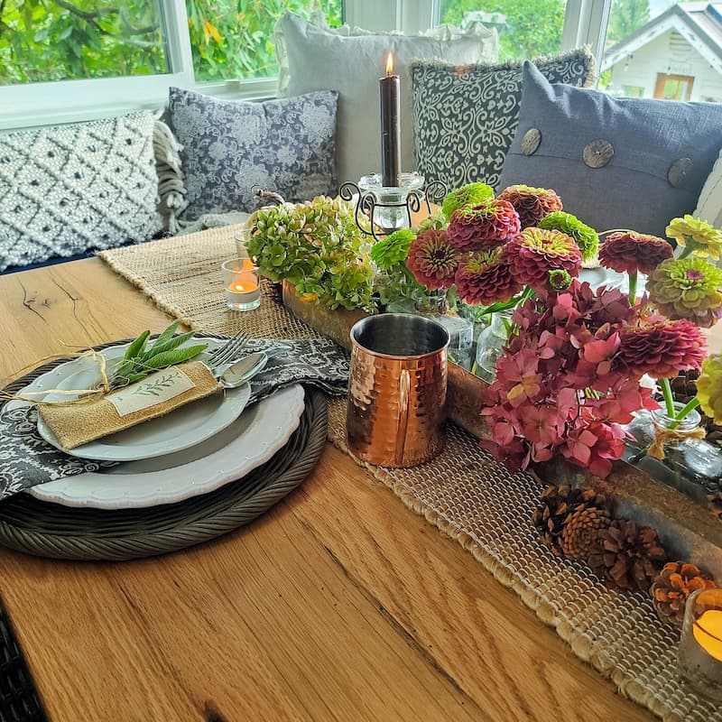 copper mug and place setting with flowers on fall tablescape