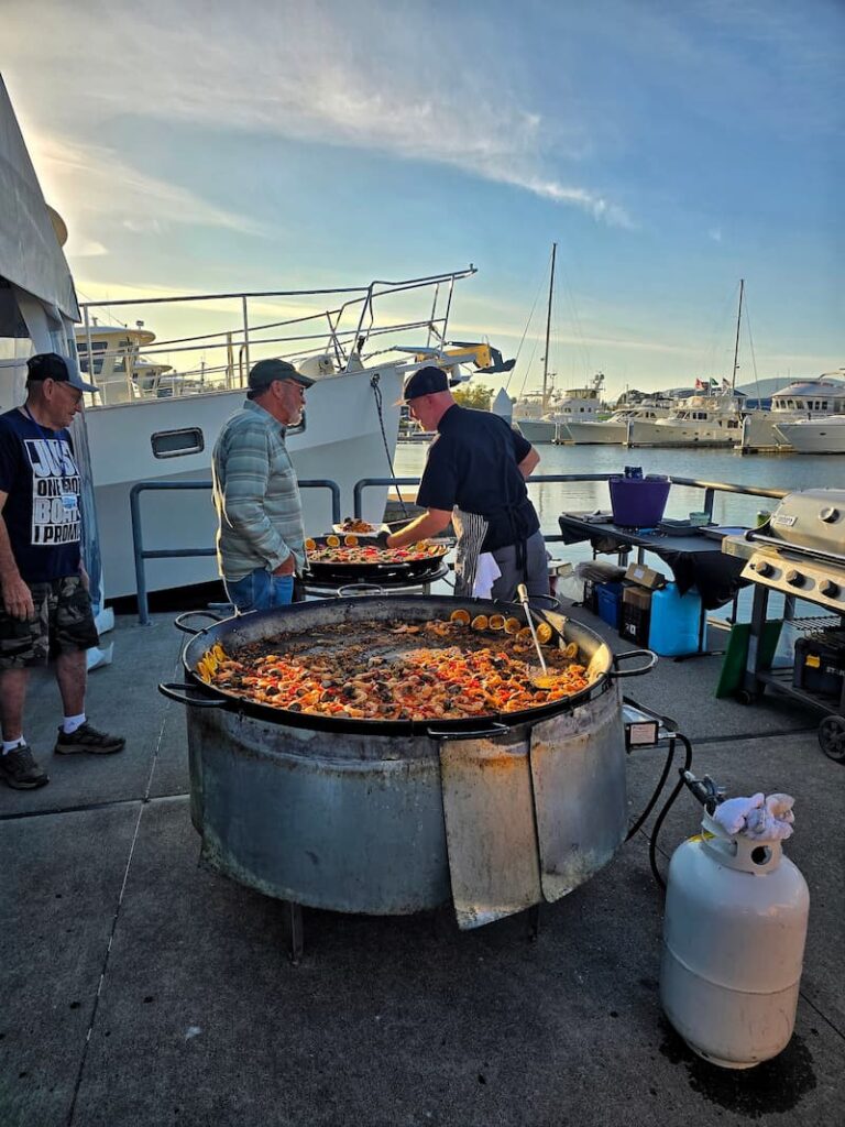 Paella cooking in a large pan on the dock at the Kadey Krogen Rendezvous