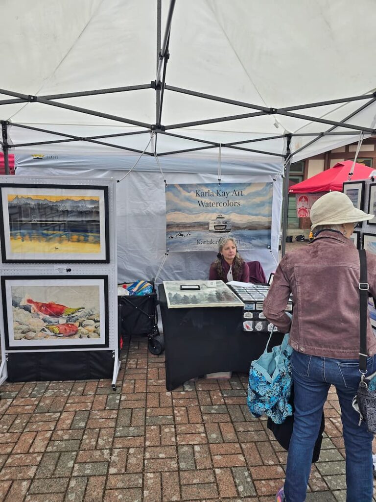 Coastal watercolor art booth at the Anacortes Farmers Market