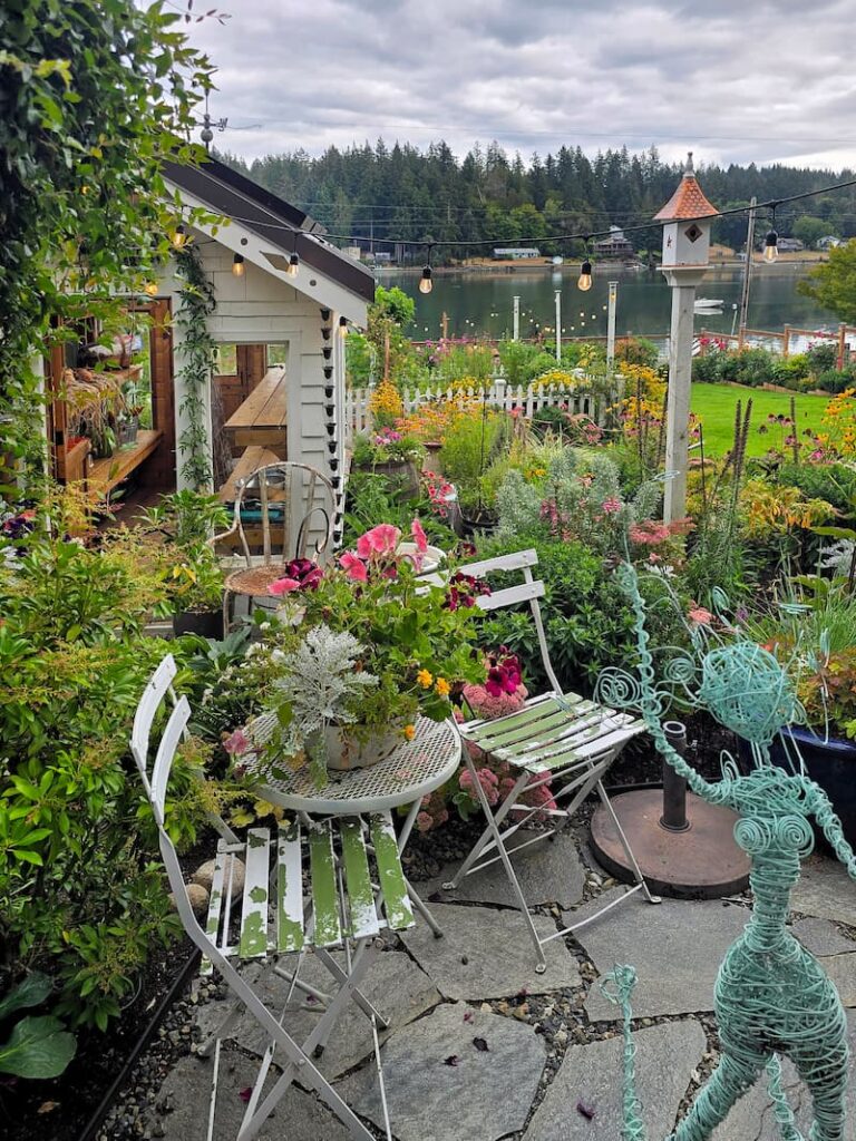 chippy bistro set on stone patio in cottage garden