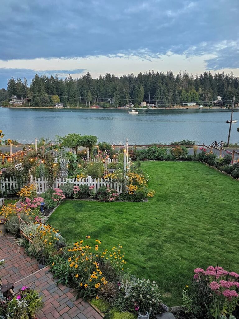 Pacific Northwest cottage garden in mid September with fall blooms and late summer perennials
