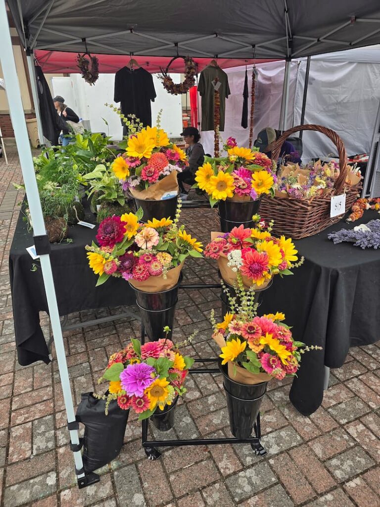 Buckets of cut flower bouquets at a flower farm booth at the Anacortes Farmers Market