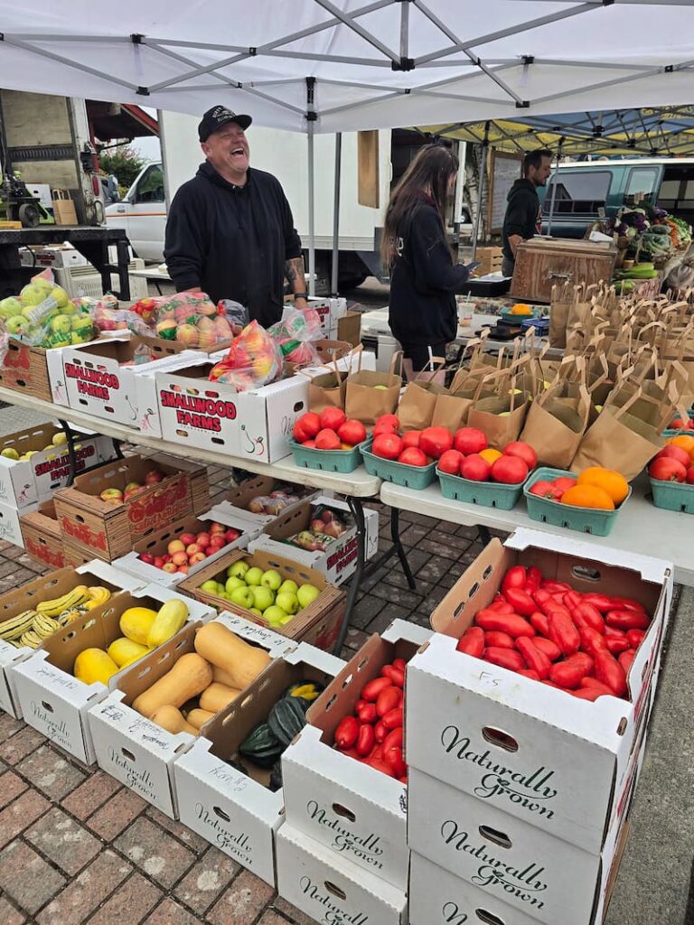 Fresh fruit and vegetables piled high at a booth at the Anacortes Farmers Market