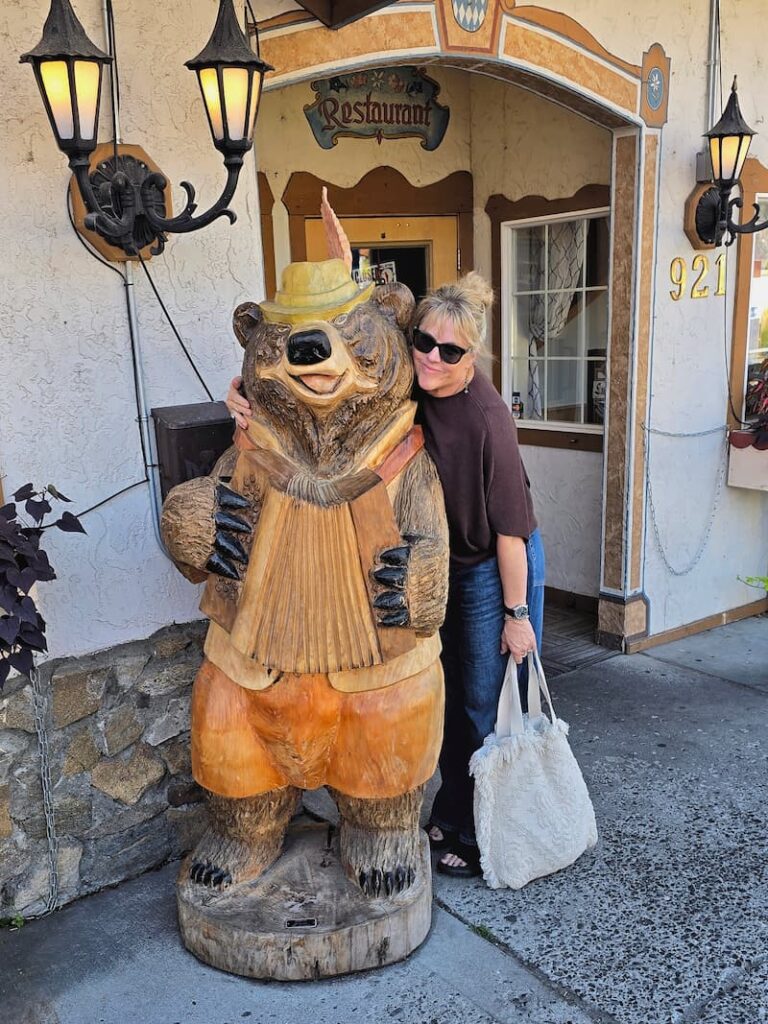 posing with a wooden bear in Leavenworth