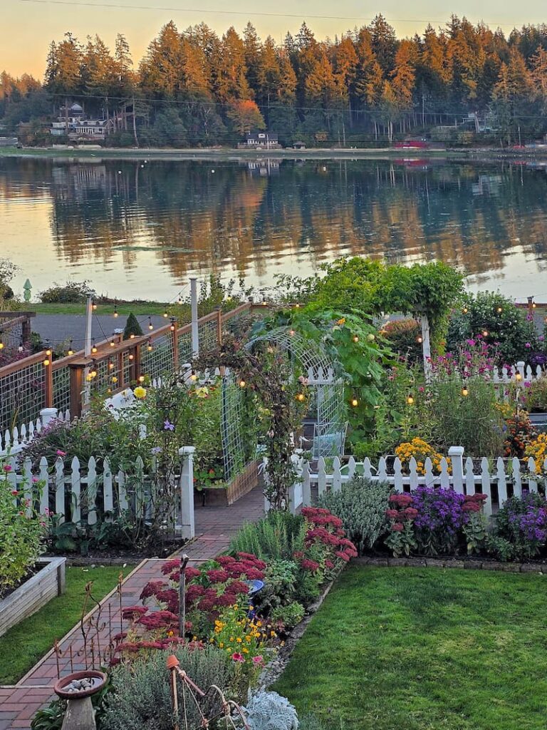 Pacific Northwest cottage garden in fall with calm water beyond