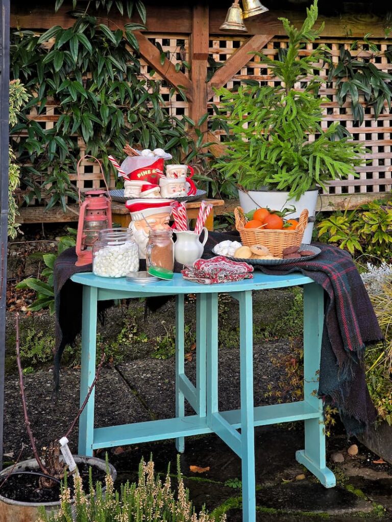 Christmas hot cocoa station set up outdoors at a beach cottage