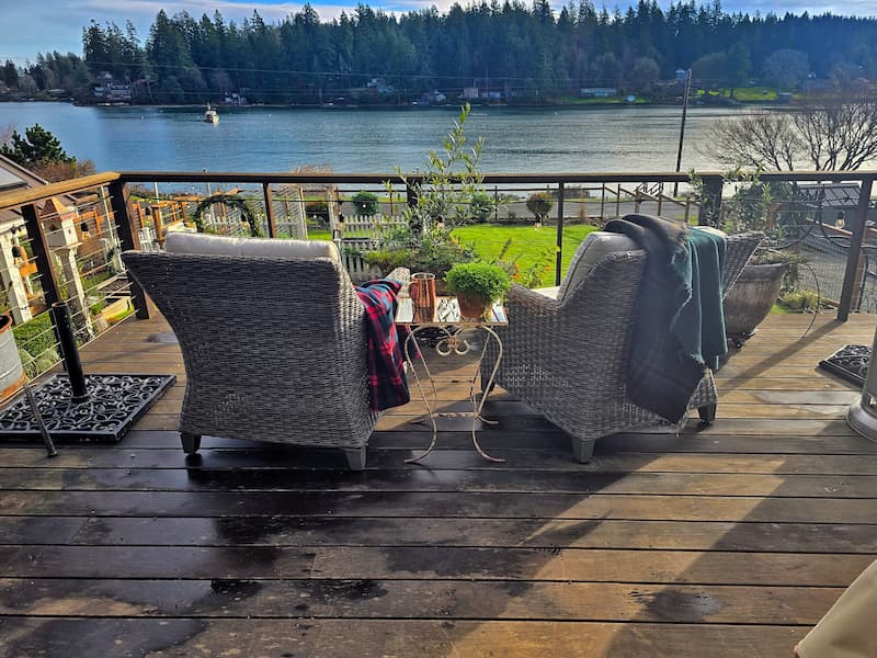 Deck seating area decorated for Christmas overlooking the bay on Puget Sound