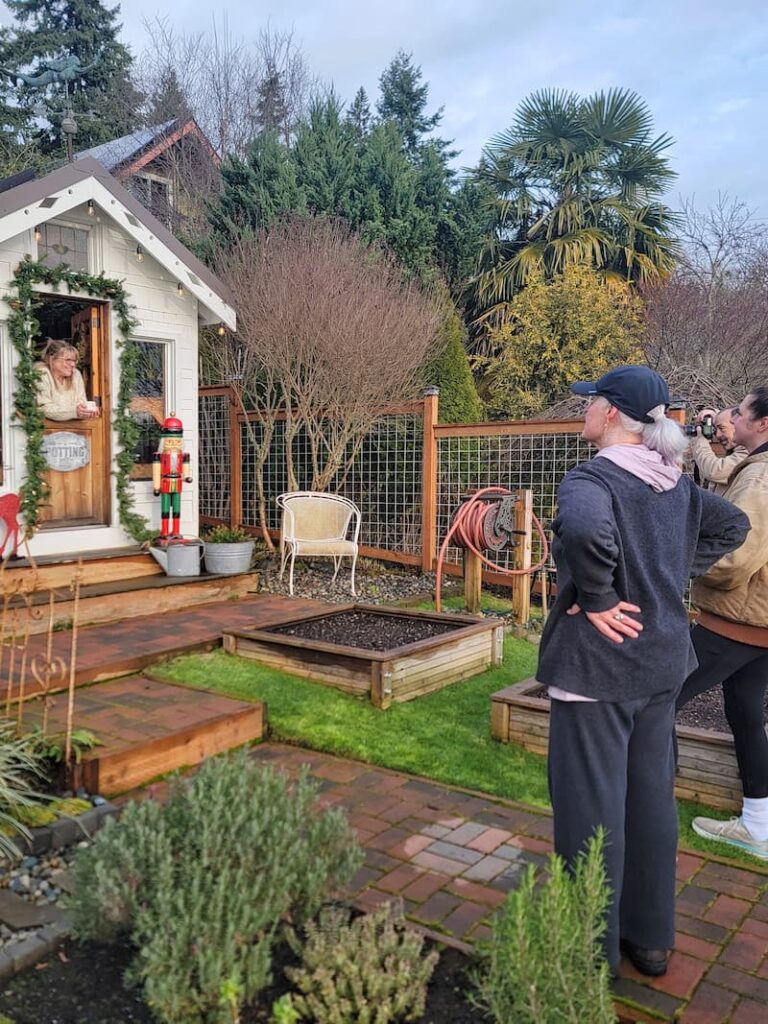 Woman posing behind a greenhouse Dutch door for a Christmas magazine shoot