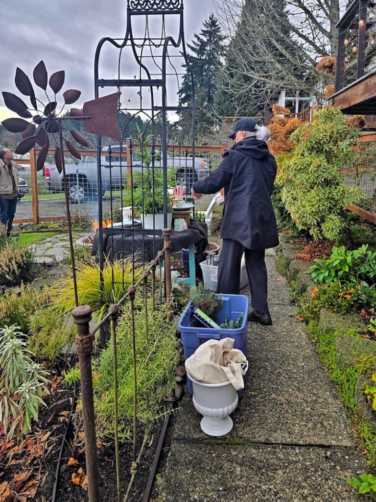 Stylist setting up an outdoor hot cocoa bar for Christmas